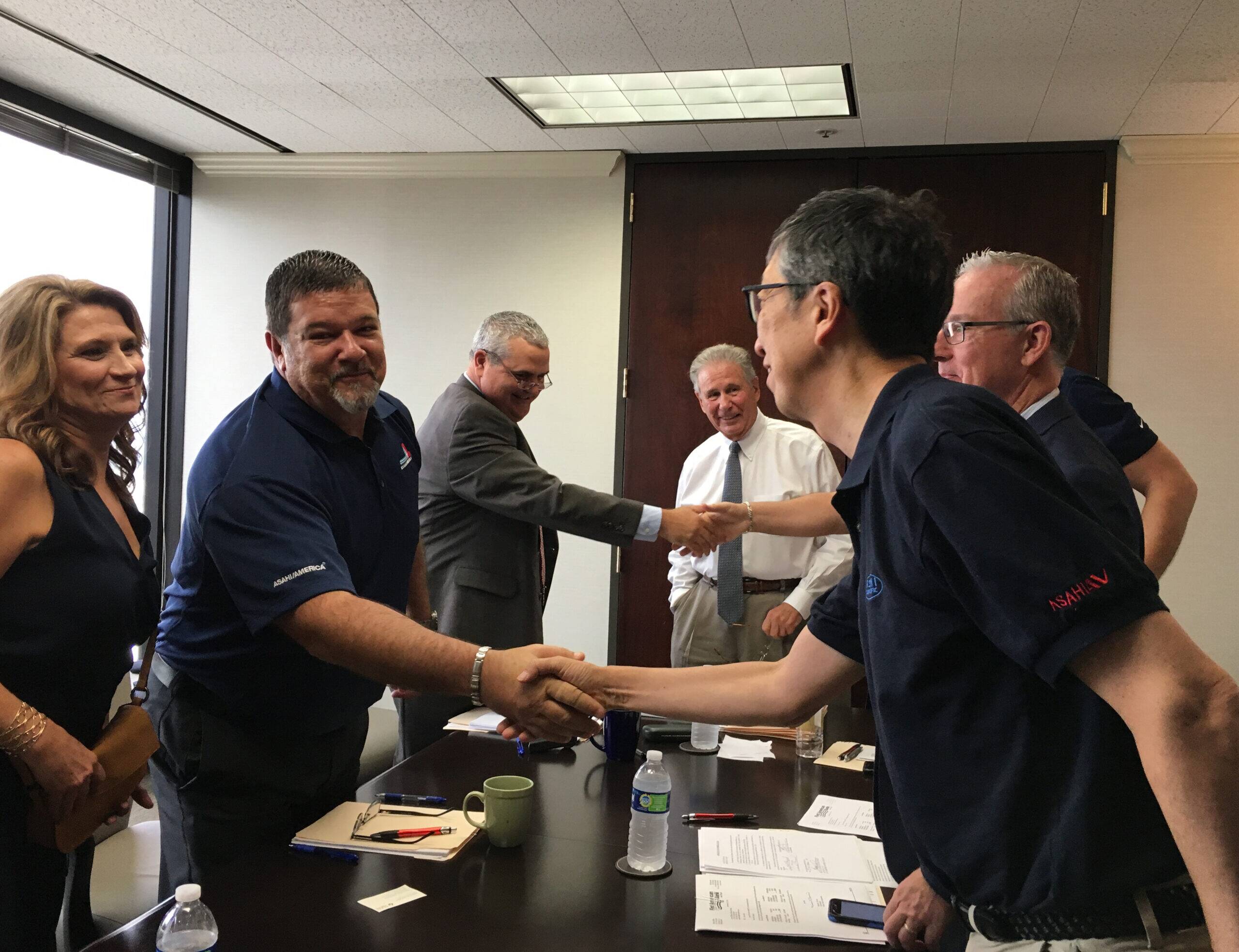 Membros da Asahi/America e da Asahi Yukizai fechando o acordo oficial de aquisição da Performance Plastics Inc. (PPI).